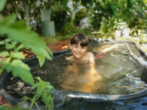 boy-having-fun-in-the-pool-in-the-summer-in-garden-2024-12-07-17-41-40-utc